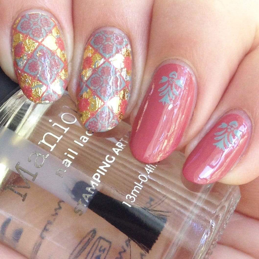 A manicured hand with Mosaic (mxm014) designs holding a top coat by Maniology.