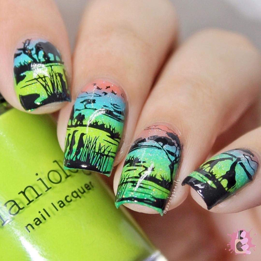 A manicured hand with landscape designs holding a polish from Maniology.