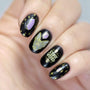 A manicured hand in black with crystals and word design by Maniology.