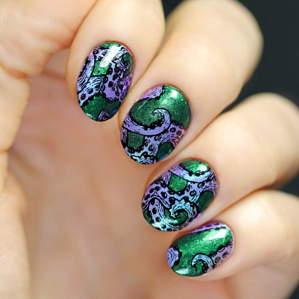 A manicured hand with octopus tail designs by Maniology (m159).