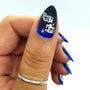 A manicured hand in blue and black with justagirlandhernails design by Maniology.