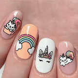 A manicured hand with rainbow and unicorns design by Maniology.