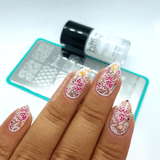 A manicured hand with flowers design by Maniology.
