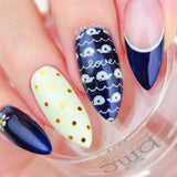 A manicured hand in blue with accent design and fish by Maniology.