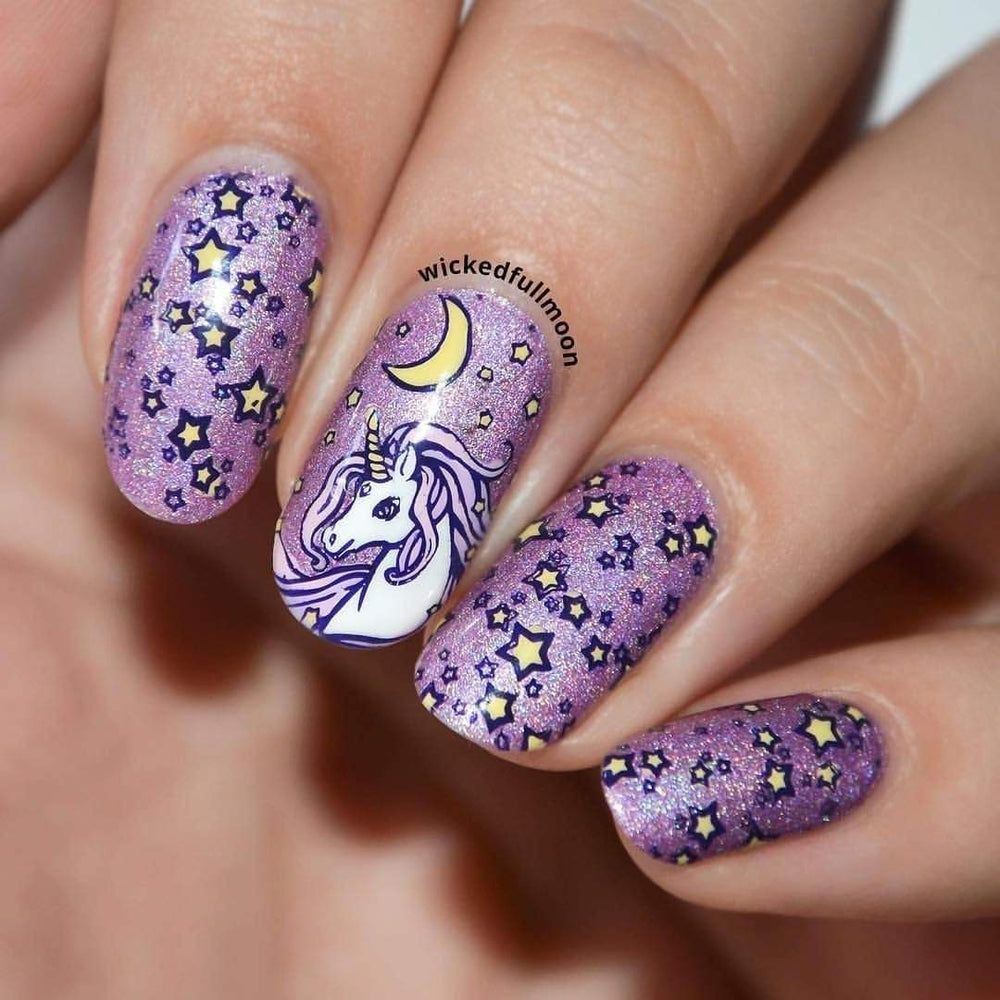 A manicured hand in purple with unicorn, stars and moon design.