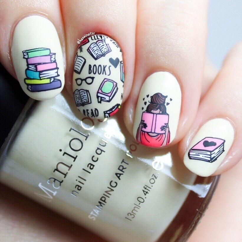  A manicured hand in white with different colors of books design holding a polish by Maniology.