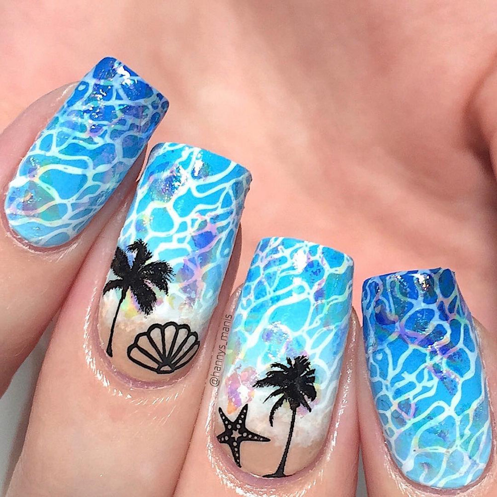 A manicured hand in blue with seashell, starfish and palm trees design.