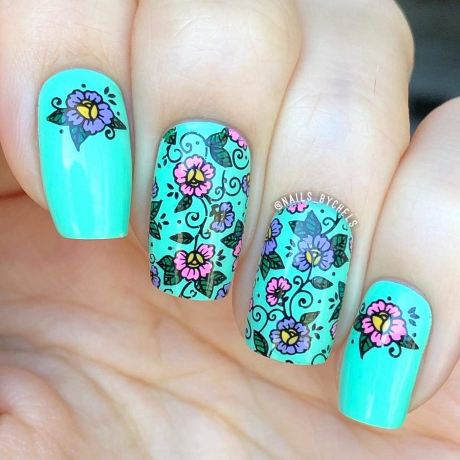 A manicured hand with wildflowers design by Maniology.