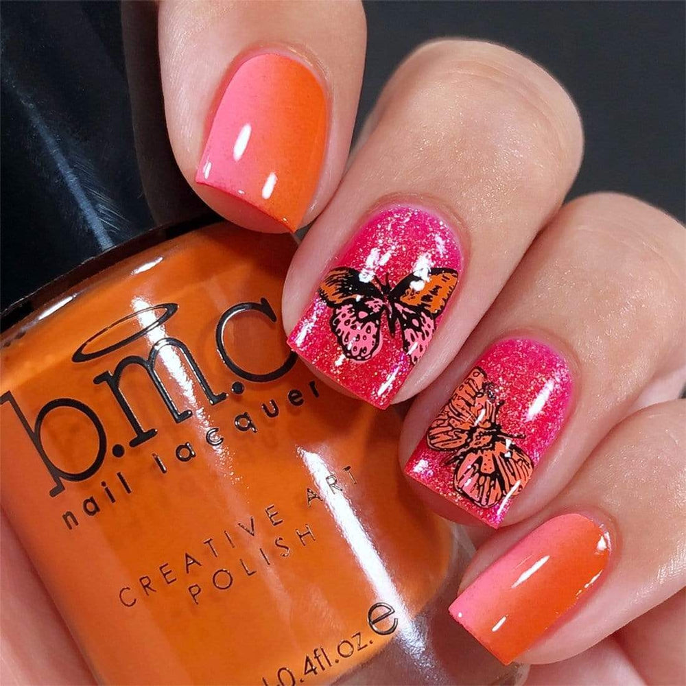 A manicured hand in butterflies design holding a polish.