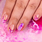 A manicured hand with flamingo design in purple and pink.