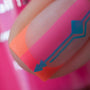 A manicured hand in pink, orange and blue with french tip design by Maniology (m052)
