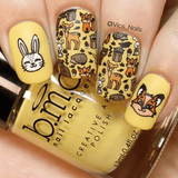 A manicured hand in yellow with different kinds of animals design holding a polish.