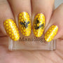 A manicured nail art in yellow with beehive and bee designs holding a stamper.