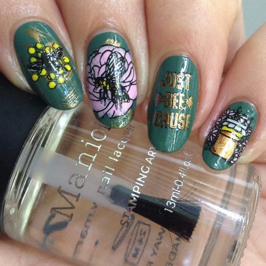 A manicured nail art with bees and honey design holding a polish from Maniology.