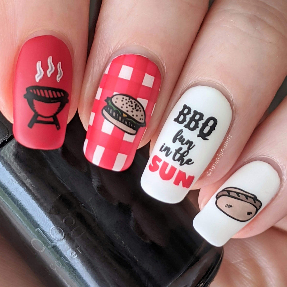 A manicured hand in red and white with burger and barbeque grill designs Sweet Thing (m100) holding a polish by Maniology .