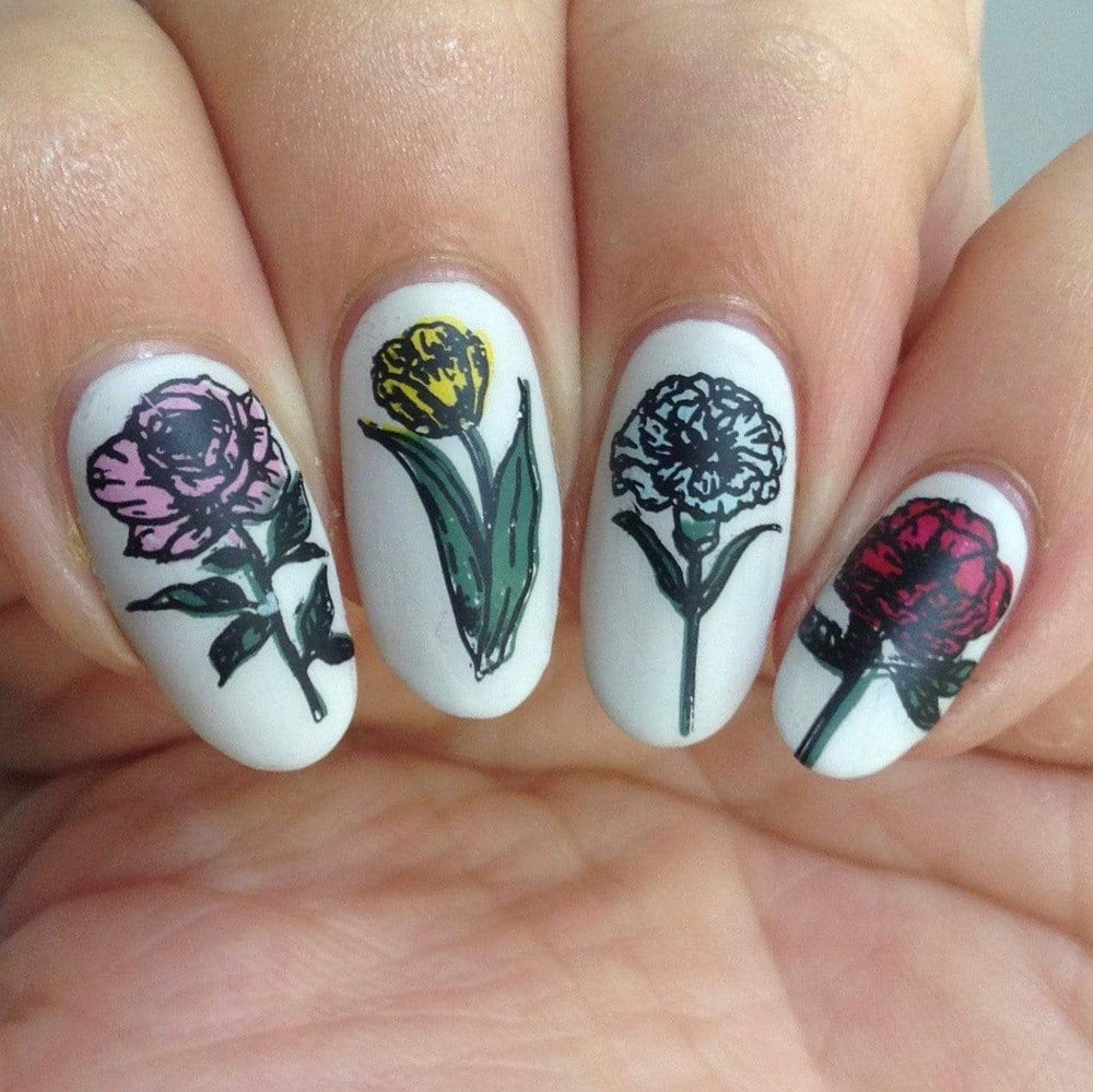 A manicured hand in 4 types of beautiful flower designs.