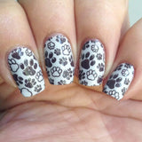 A manicured  hand in black and white with dog paws design by Maniology Puppy Love (m097).