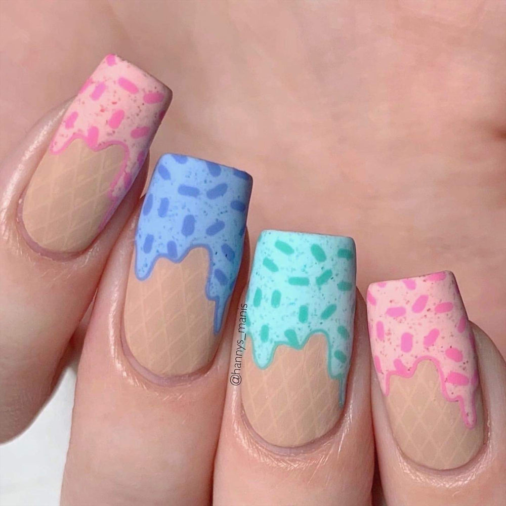 A manicured hand with sprinkles cupcake design by Maniology Sweet Thing (m100).