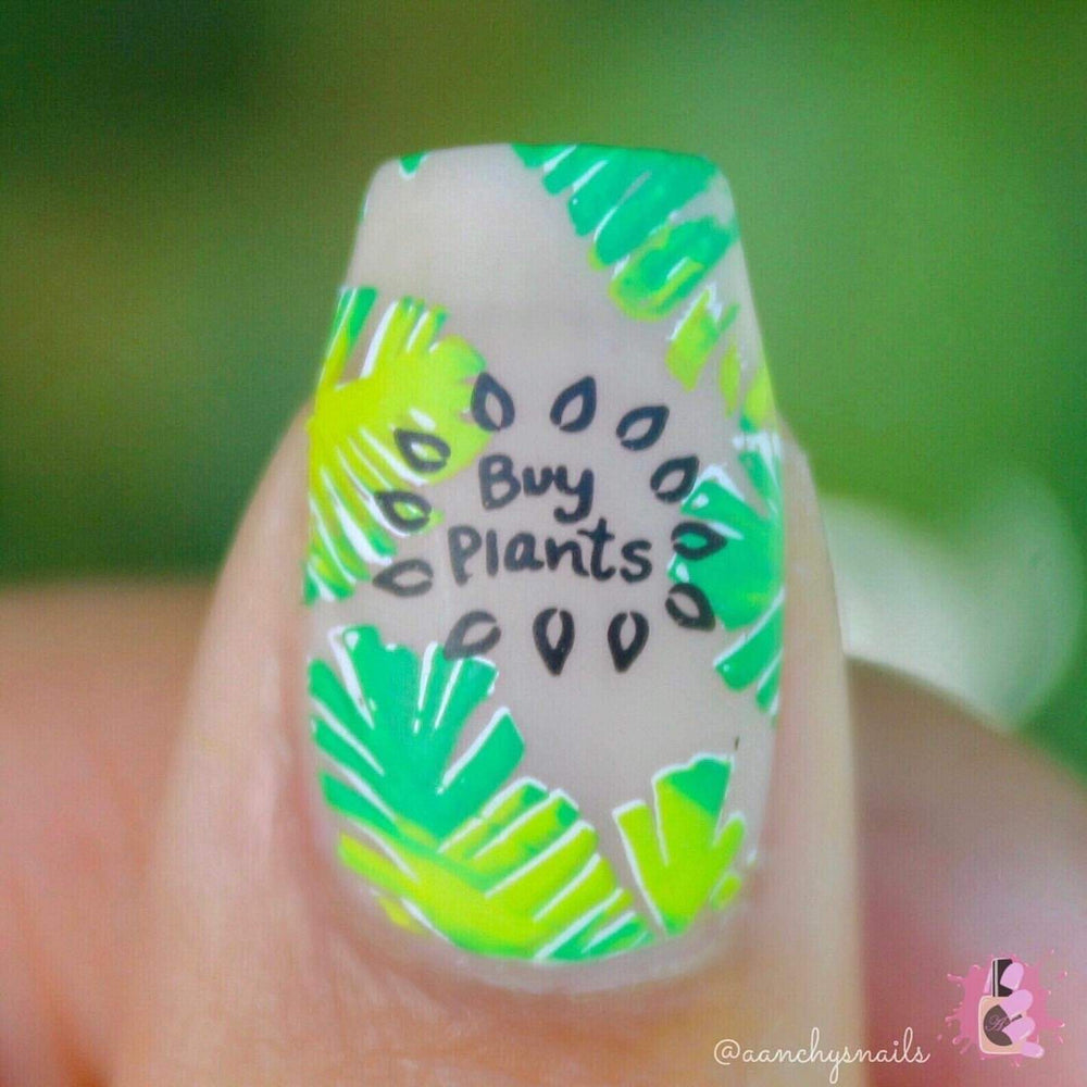 A manicured hand with leaves design by  Maniology Wave Your Palms (m095).
