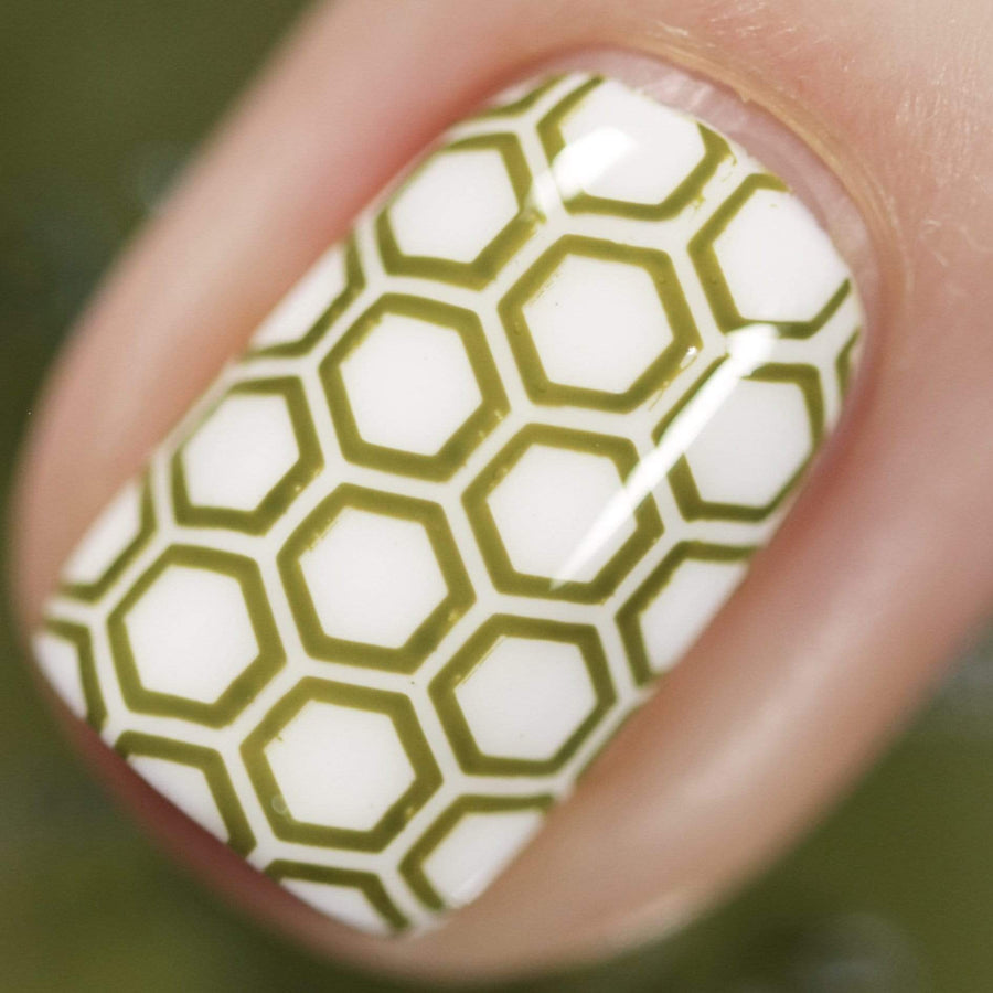A manicured hand made with olive green stamping polish from Stocking Stuffer Evergreen (B315).