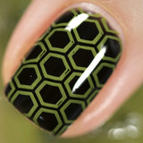 A manicured hand made with olive green stamping polish from Stocking Stuffer Evergreen (B315).