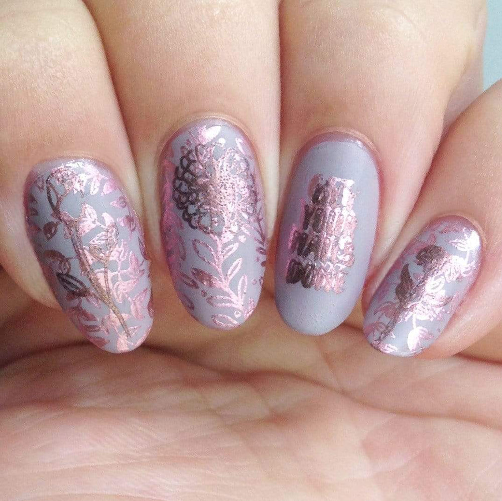 A manicured hand with Autumn Wishes designs by Maniology (m164).