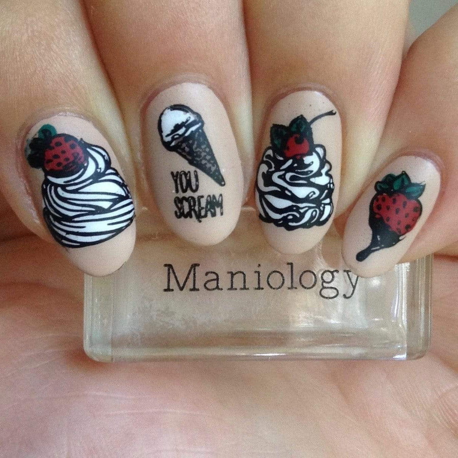 A manicured hand with ice cream, cherry and strawberries design holding a stamper.