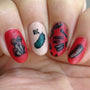 A manicured hand in red with mushrooms and sausage designs.
