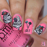 A manicured hand in pink with an ice cream design with toppings of strawberry, cherry, and lollipops holding a polish.