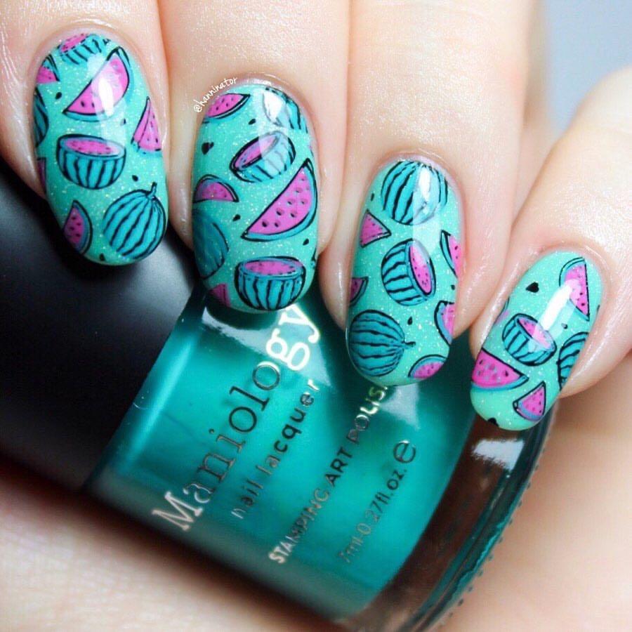 A manicured hand with layered watermelon designs by Maniology (m028).