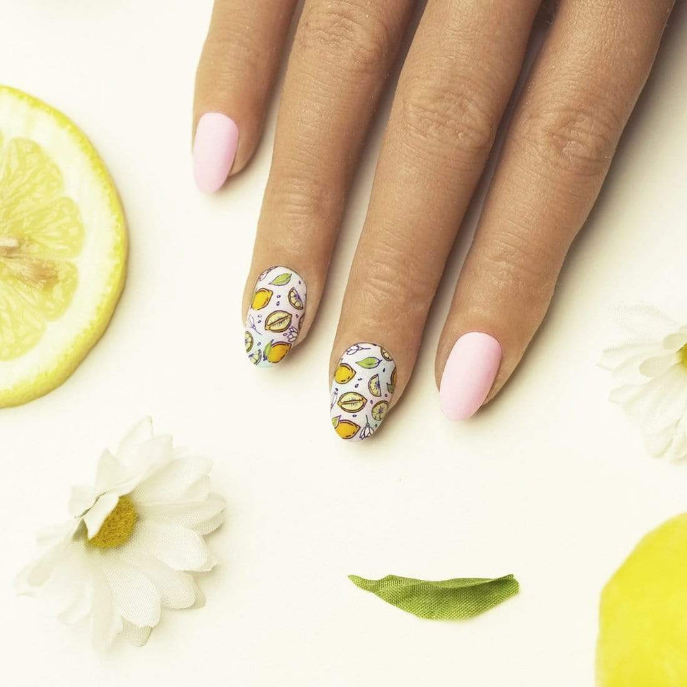 A manicured hand with layered fruit designs by Maniology (m028).