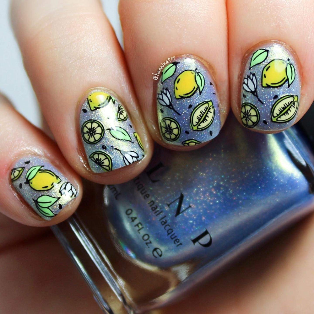 A manicured hand with layered lemon designs by Maniology (m028).