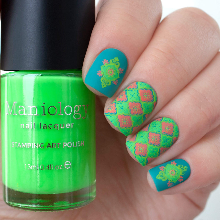 A manicured hand with layered tile designs holding a polish by Maniology (m029).