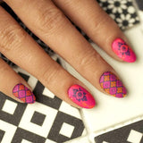  A manicured hand in pink with layered tile designs by Maniology (m029).