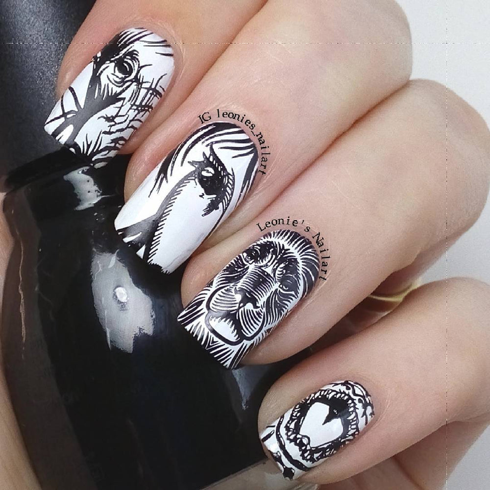 A manicured hand with horse and lion  designs in black and white by Maniology (m135).