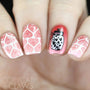 A manicured hand in white and red with hearts design by Maniology.