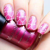 A manicured hand in full of hearts design holding a polish by Maniology.