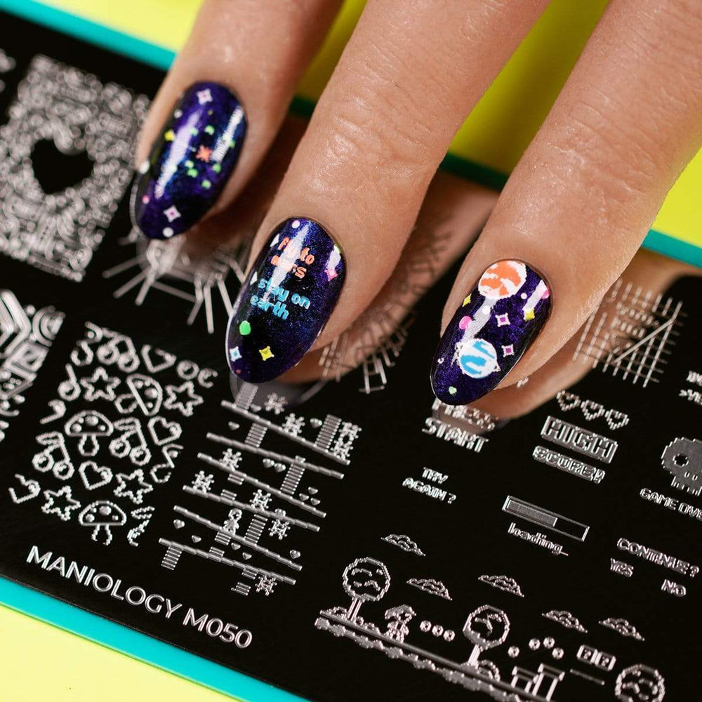  A manicured hand with a variety of arcade screen design over a nail stamping plate by Maniology (m050)