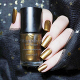 A manicured hand holding a Soulless - Dark Bronze Duochrome Creative Art Stamping Polish by Maniology.