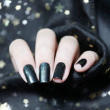  A manicured hand with the use of Mirror, Mirror - Smoky Black stamping polish by Maniology.