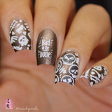 A manicured hand in black and white with bad to the bones designs by Maniology (m158).