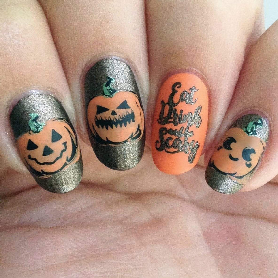 A manicured hand with Halloween pumpkins design by Maniology (m158).