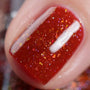 A close up of a nail featuring Maniology sheer polish Bolt, an orange brown flakie nail polish