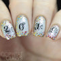 A manicured hand in gray with fireworks and numbers design.
