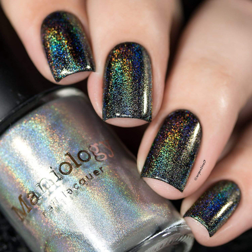 A manicured hand made with Holo Prism Top Coat by Maniology.