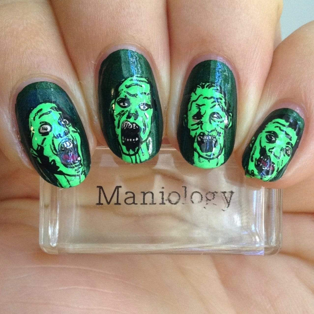  A manicured hand with Blood thirsty zombies design holding a stamper by Maniology (m062).