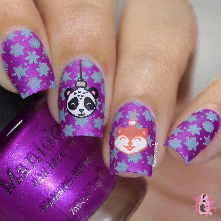  A manicured hand in violet with holiday and animal ornaments design holding a polish by Manilogy.