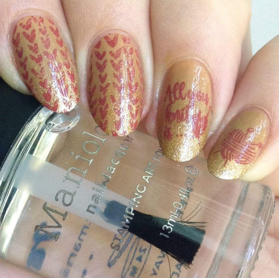 A manicured hand with Knotty by Nature stamping plate designs holding a top coat by Maniology (m177)