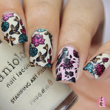 A manicured hand with koi fish and flowers design holding a polish by Maniology.