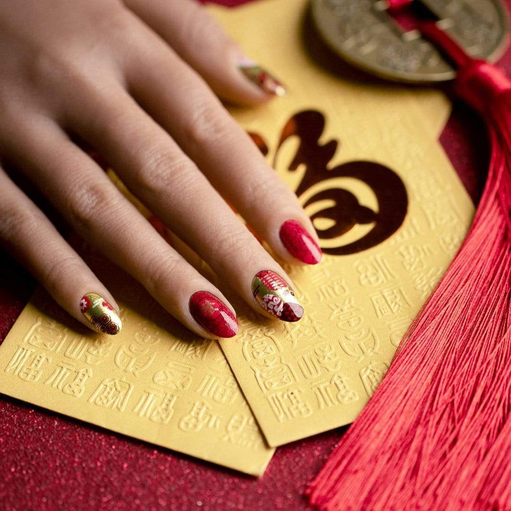 A manicured hand with Lunar New Year Occasions: Prosperity designs by Maniology (m043).